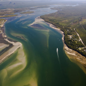 A boat navigates the Fitzroy Basin estuary. 