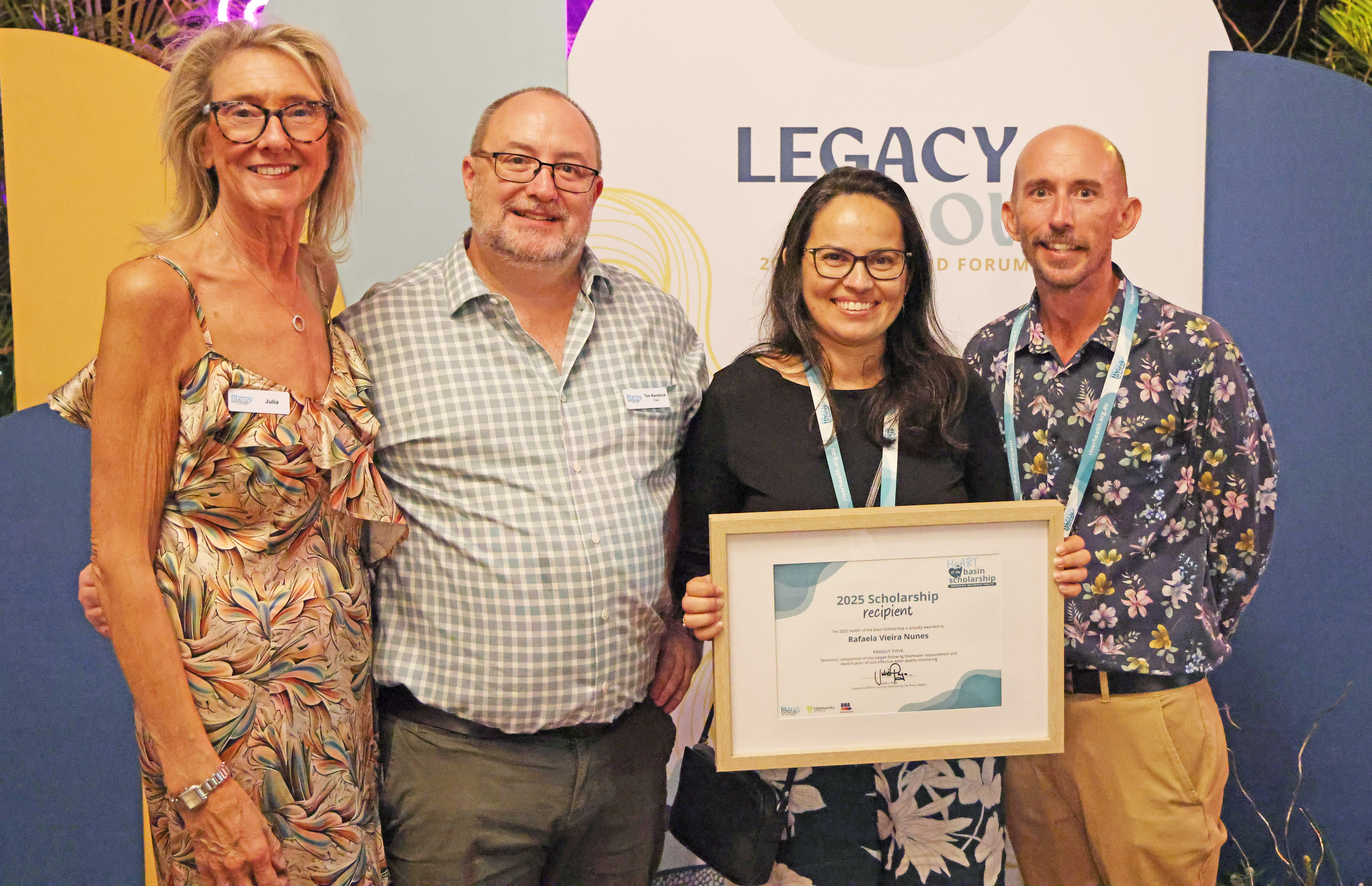 Rafaela Vieira Nunes (middle) is presented a HeART of the Basin Scholarship from Partnership representatives. 